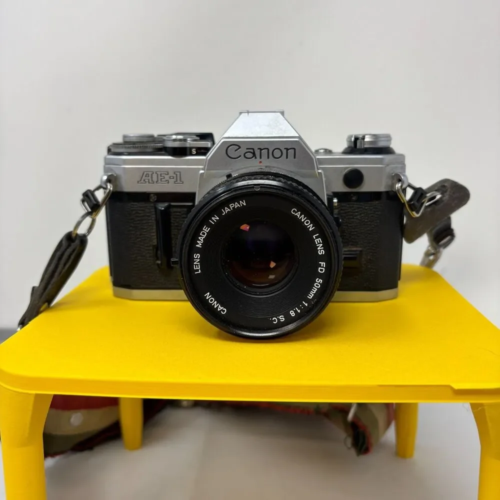 Canon AE-1 35mm SLR Film Camera W/ 2 Lens, Flash, Case, Paperwork UNTESTED